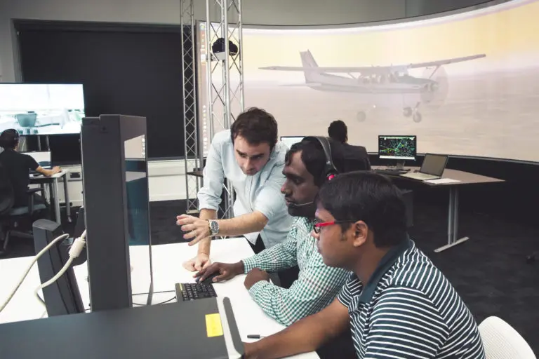 2017-05-CEAP0025CEAP0035CEAP-AIRC-Air Traffic Management Lab-students and tutor with aircraft on lit screen behind-landscape-01