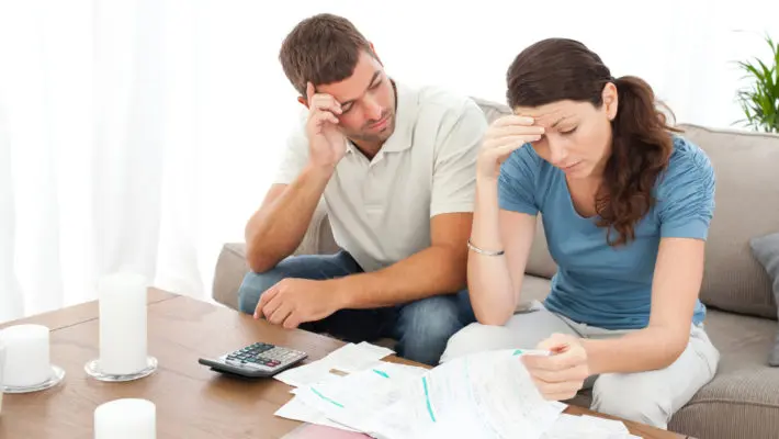Worried couple doing their accounts