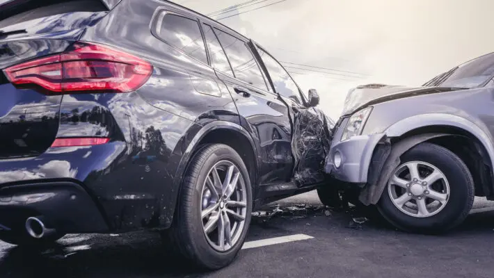 Car crash dangerous accident on the road. SUV car crashing beside another one on the road..
