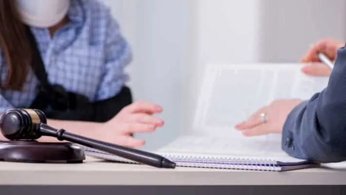 Injured employee visiting lawyer for advice on insurance