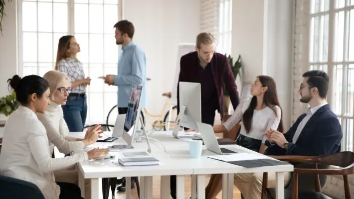 Diverse concentrated successful young businesspeople workday in modern office.