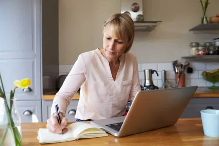 Woman Working From Home On Laptop In Modern Apartment