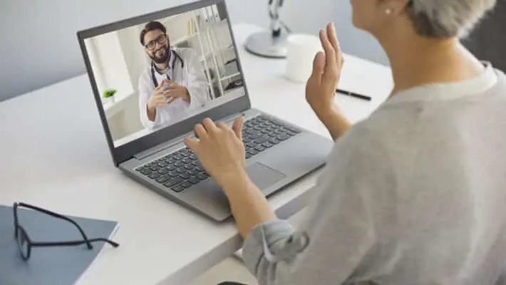 Cyber medicine. Mature lady talking to doctor online from home. Medical specialist consulting senior patient on webcam