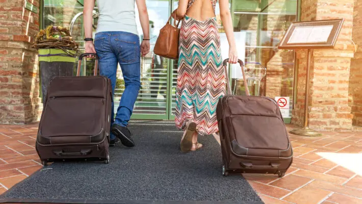 Young couple standing in hotel corridor
