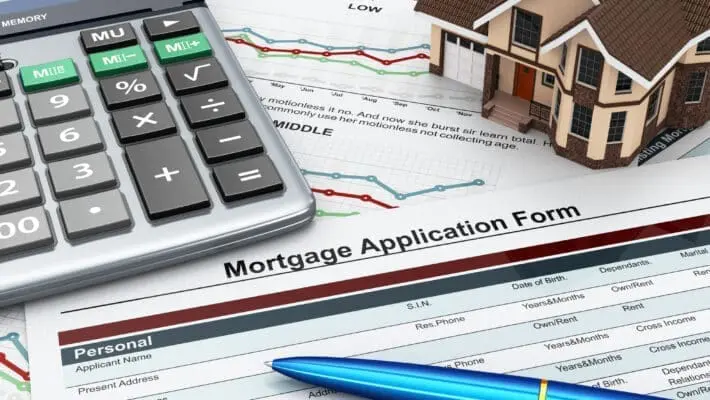 Mortgage application form with a calculator and house.