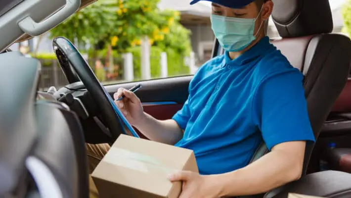 Asian,Delivery,Courier,Young,Man,Driver,Inside,The,Van,Car