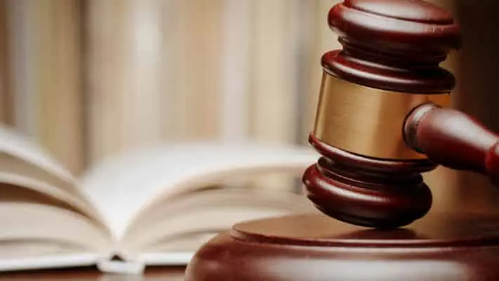 Wooden,Gavel,Resting,On,Its,End,On,A,Wooden,Table