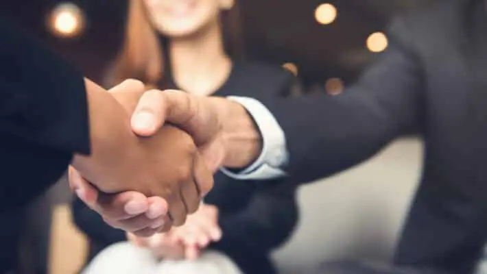 Businessmen,Making,Handshake,With,His,Partner,In,Cafe,-,Business