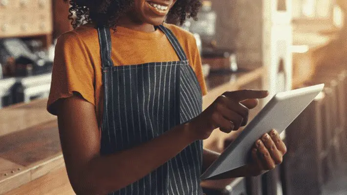 VE woman using tablet in cafe portrait
