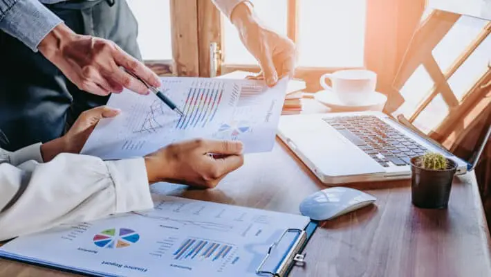 Business,Team,Analyzing,Income,Charts,And,Graphs,With,Modern,Laptop