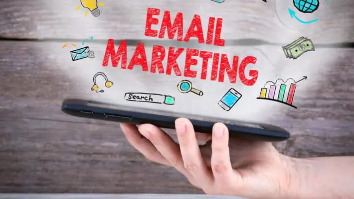 Email,Marketing,Concept.,Tablet,Computer,In,The,Hand.,Old,Wooden