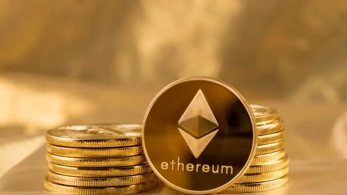Stack,Of,Ether,Coins,Or,Ethereum,On,Gold,Background,To