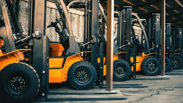 Background,Of,A,Lot,Of,Forklifts,,Reliable,Heavy,Loader,,Truck.