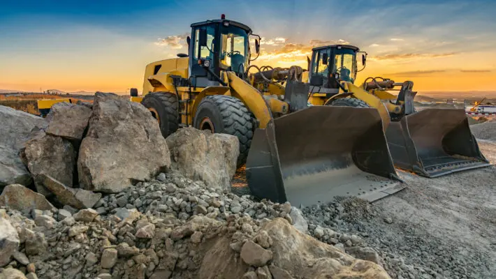 Two,Excavators,Moving,Stone,And,Rock,In,A,Construction,Site
