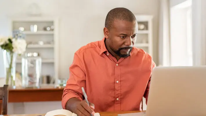 Mature,Man,Working,On,Laptop,While,Taking,Notes.,Businessman,Working