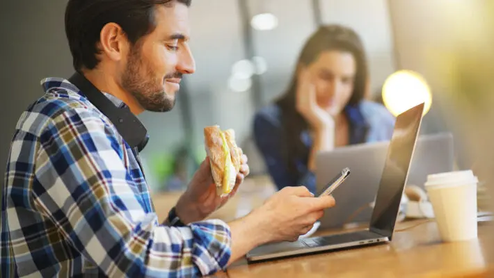 Attractive,Man,Eating,Sandwich,Whilst,Working,In,Co,Working,Space