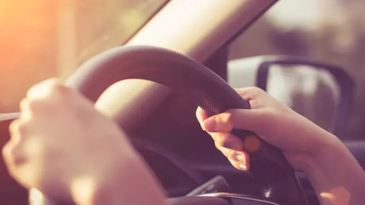 Female,Hands,On,The,Steering,Wheel,Of,A,Car,While