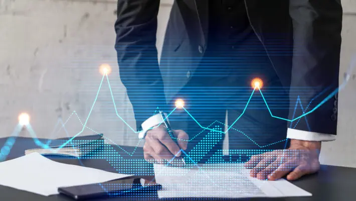 Businessman,In,Suit,Signs,Contract.,Double,Exposure,With,Financial,Chart