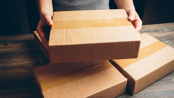 Girl’s,Hands,Holding,The,Package,On,The,Table