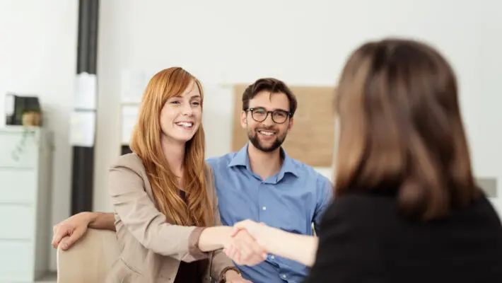 Happy,Young,Couple,Meeting,With,A,Broker,In,Her,Office