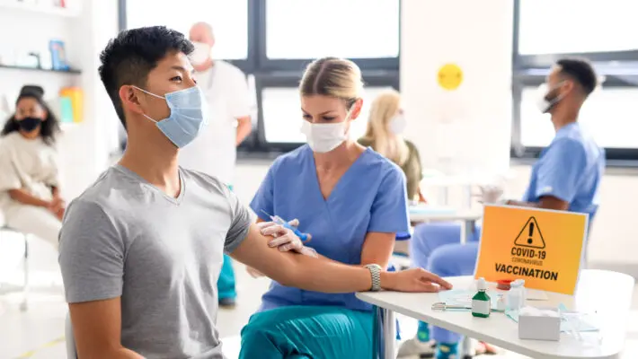 Employers in the UK are following the lead of their counterparts in the US by stepping up demands for staff to be vaccinated against Covid-19, analysis of recruitment adverts reveals.
