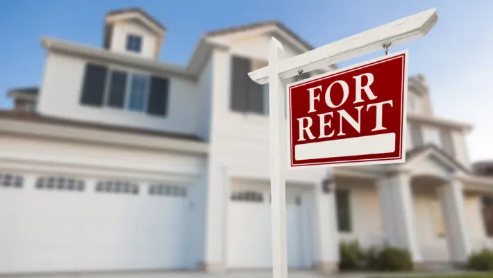 Red,For,Rent,Real,Estate,Sign,In,Front,Of,Beautiful