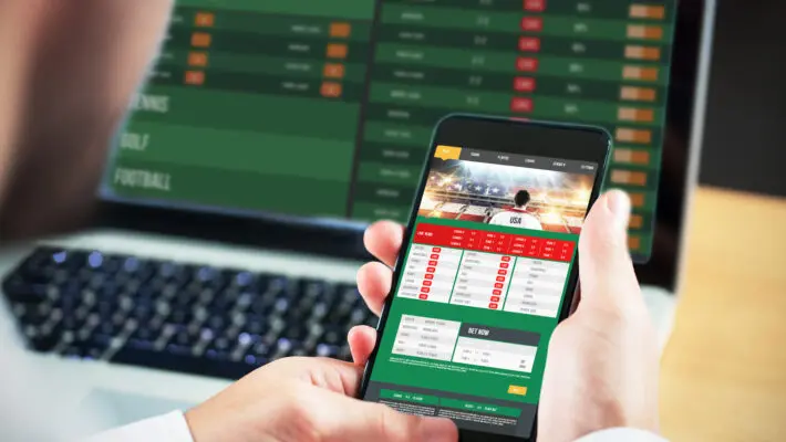 Businessman,Using,Smartphone,Against,Gambling,App,Screen
