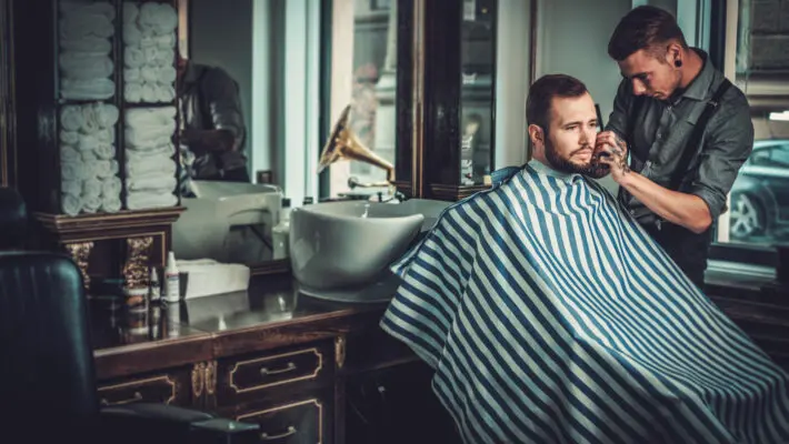 Confident,Man,Visiting,Hairstylist,In,Barber,Shop