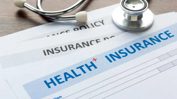 Health,Insurance,Form,With,Stethoscope,In,Top,View