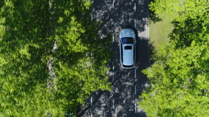 Aerial,Top,Down,View,Of,Grey,Station,Wagon,Vehicle,Overtaking