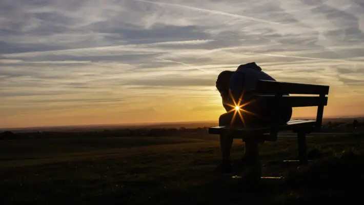 Sad,Unhappy,Silhouette,Man,Sitting,With,His,Head,In,His