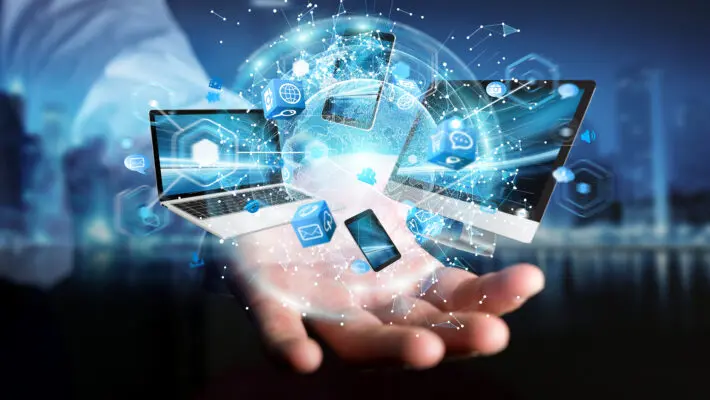 Tech,Devices,Connected,To,Each,Other,By,Businessman,On,Blurred