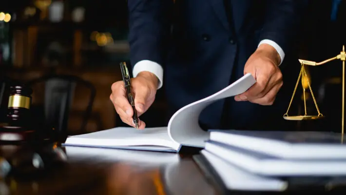 Close,Up,Lawyer,Businessman,Working,Or,Reading,Lawbook,In,Office