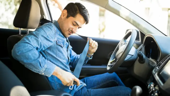 Young,Latin,Man,Sitting,On,Car,Seat,Fastening,Seat,Belt