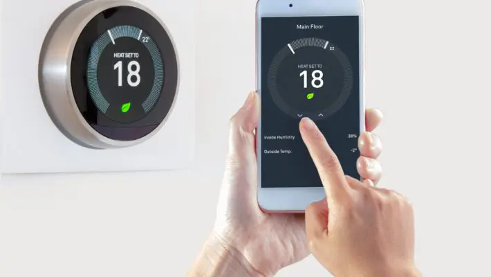 Smart,Thermostat,With,A,Person,Saving,Energy,With,A,Smart