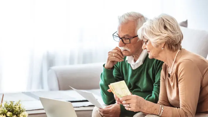 Senior,Couple,Working,On,Home,personal,Finance,Using,Laptop,With,Concerned