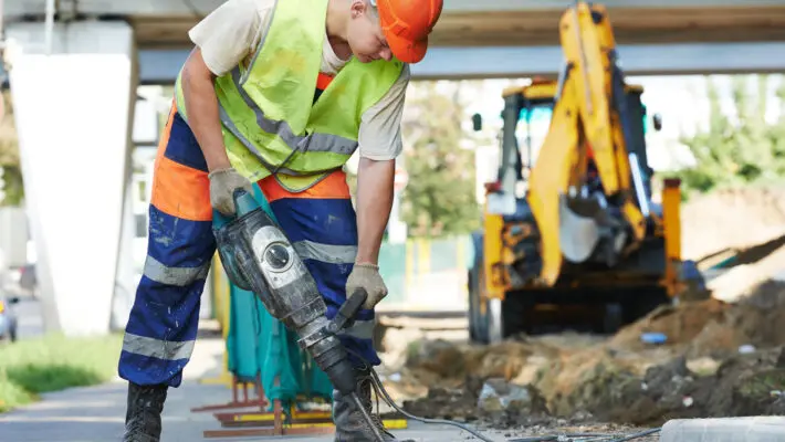 Builder,Worker,With,Pneumatic,Hammer,Drill,Equipment,Breaking,Asphalt,At