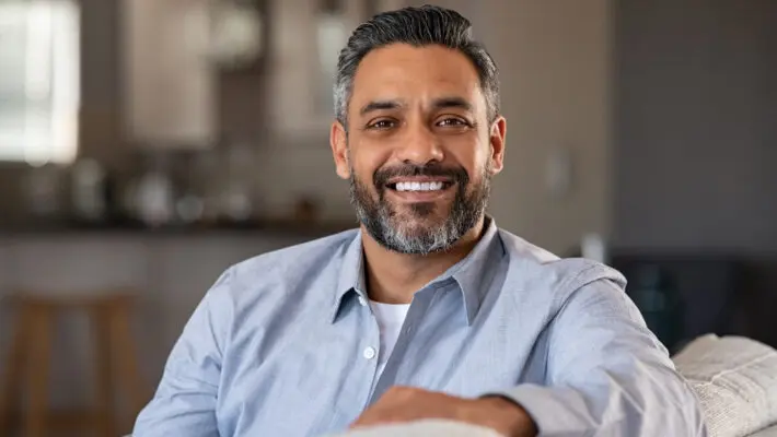 Portrait of happy indian man smiling at home