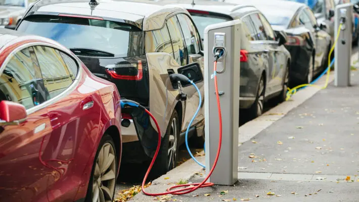 Plans to ensure half of all new cars sold in the UK are fully electric by 2028 will drive down electric vehicle (EV) prices "further and faster," experts have said.