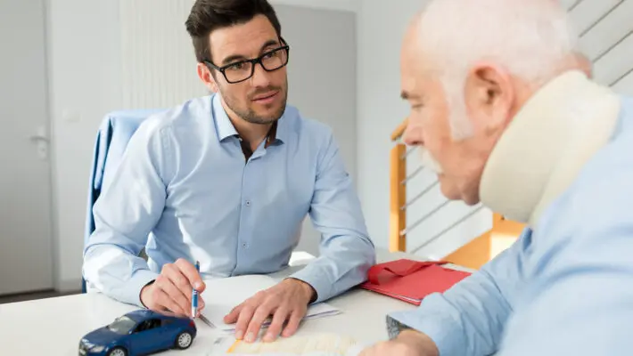 Personal,Injury,Lawyer,In,Meeting,With,Client,Wearing,Neck,Brace