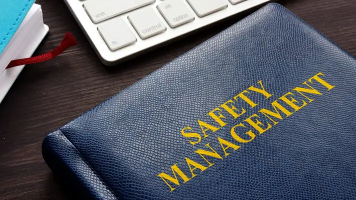 Safety,Management,Book,And,Keyboard,On,A,Desk.