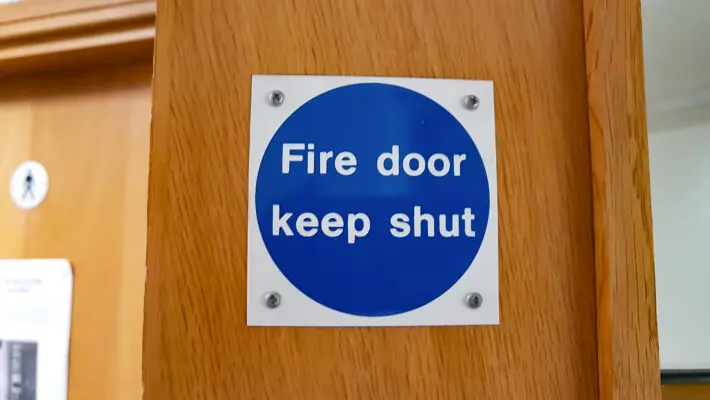 A,Small,Square,Blue,Fire,Door,Sign,On,A,Light