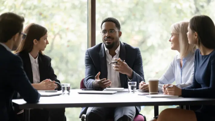 Engaged,Motivated,African,American,Business,Leader,Talking,To,Team,,Meeting