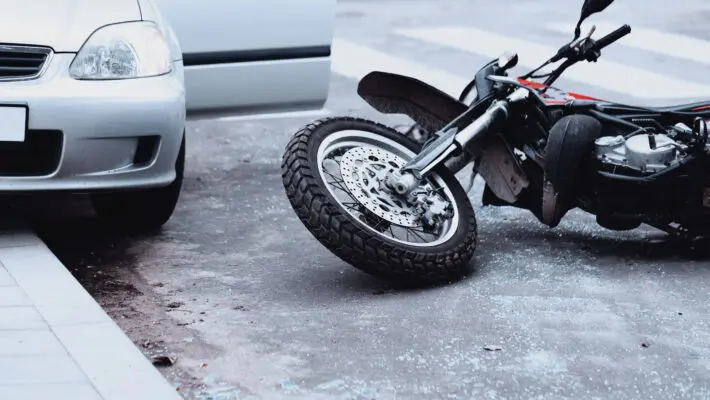 Motorcycle,Lying,On,The,Road,And,Car,Standing,With,Open