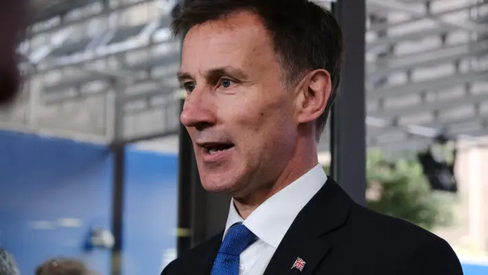 Jeremy Hunt is to delay a penny cut in income tax, the flagship announcement in the disastrous mini-budget, to help plug a black hole in the public finances that had reached £72 billion.