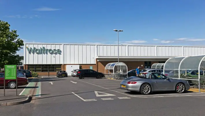 The John Lewis Partnership has struck a £500m deal with the investment firm Abrdn to build 1,000 residential rental homes, redeveloping three sites already owned by its Waitrose and eponymous retail store chains.