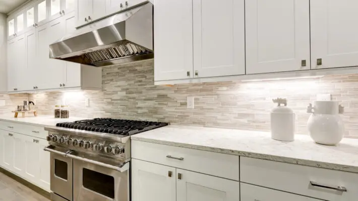 Gourmet,Kitchen,Features,White,Shaker,Cabinets,With,Marble,Countertops,Paired