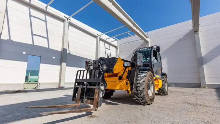 Industrial warehouse construction. Rotating telehandler vehicle
