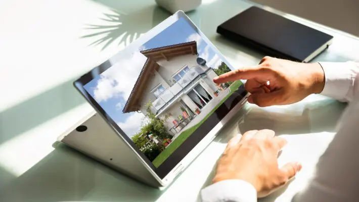 Close-up,Of,Businessman’s,Hand,Checking,House,On,Laptop