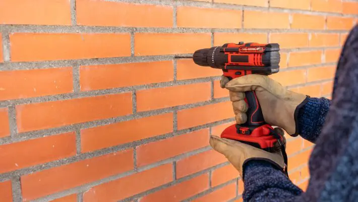 Drilling,Machine,With,Battery,Making,Holes,In,A,Brick,Wall